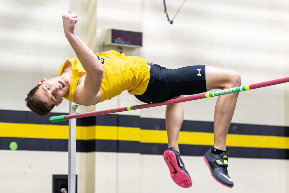 Brady Palen, a junior high jumper, attempts to clear the high jump bar at the Herm Wilson
Invitational. Palen won the event, jumping seven feet, one-half inch, three inches off his
career high.