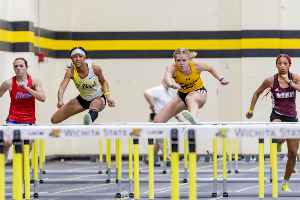 Cloud County CC hurdler Chenessa Davis and Wichita State’s Kenisa Meyer race against one another at the Herm Wilson Invitational on Jan. 27.