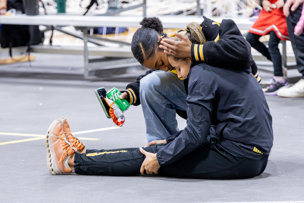 Two track athletes sit together during the only indoor track and field meet for Wichita State. The meet took place at the Heskett Center on Jan. 27.