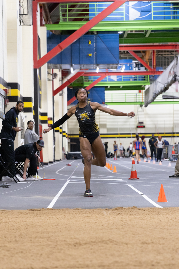 Junior Chidera Okoro jumps to the pit in her final jump of triple jump at the Wilson Invitational on Jan. 26. Okoro placed first overall with a mark of 39 feet, seven and three-quarter inches. This was a foot and a half more than the second place place winner.