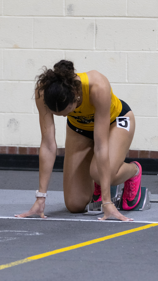 Sonya Haylor, a freshman sprinter and jumper steps into her blocks for the 60 meter preliminaries at the Wilson Invitational on Jan. 27. Haylor placed 21st in preliminaries, not making it to finals.
