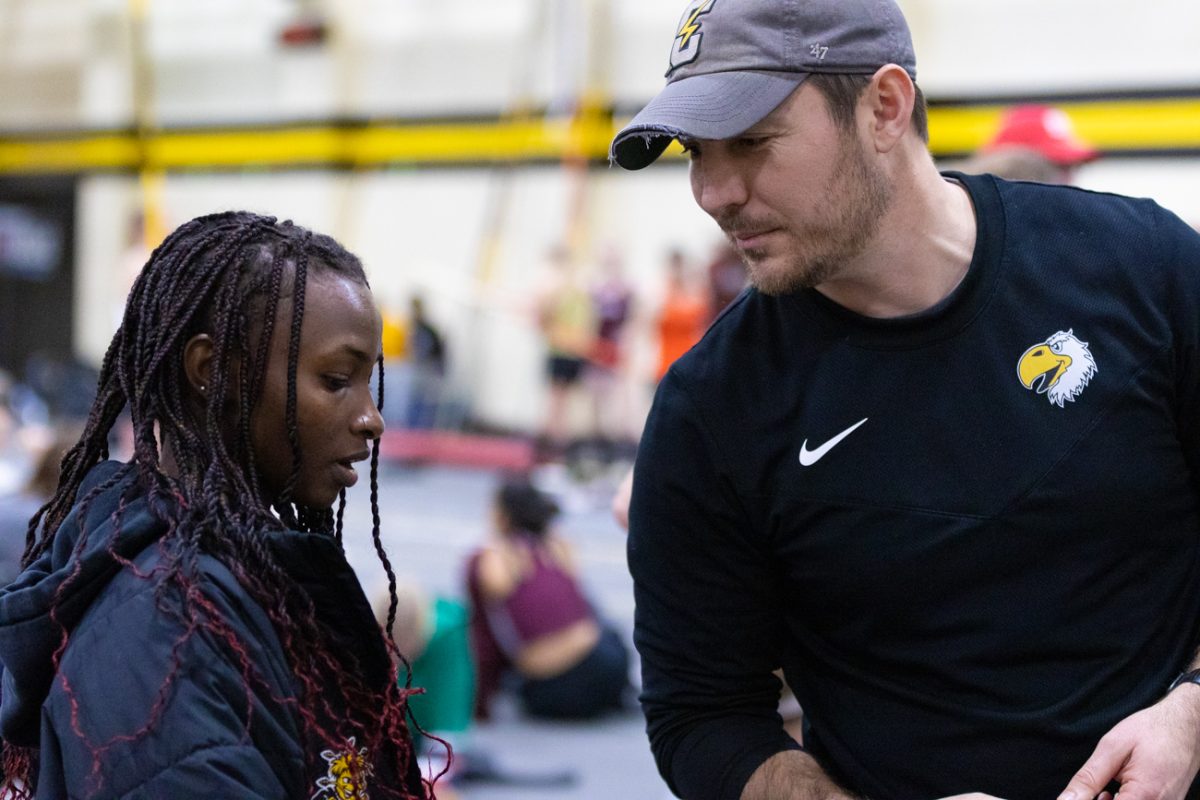 Junior Lucy Ndungu speaks with former coach Drew Mahin from Cloud County Community College at the Wilson Invitational on Jan. 26. Ndungu transfered to Wichita State during the fall 2023 season from CCCC.