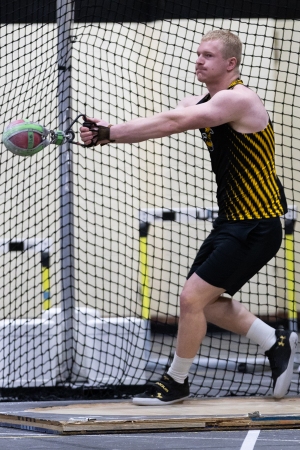 Junior thrower Creighton Camp prepares for his first weight throw on Jan. 26 at the Wilson Invitational. Camp won in the competition with a throw of 53 feet, four and one-half inches.