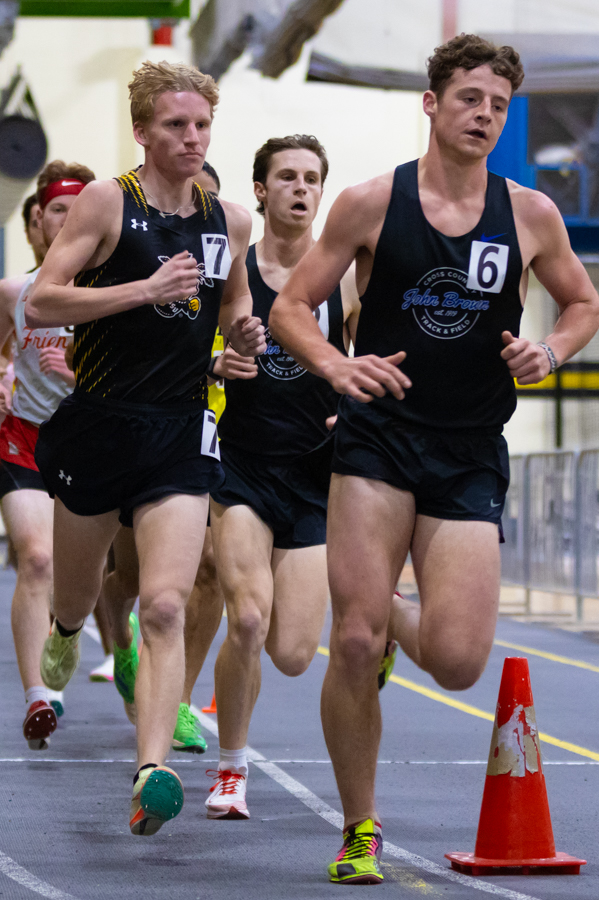 Bennett Meoli follows closely behind a John Brown distance athlete at the Wilson Invitational Jan. 26 during the 5000 meter race.