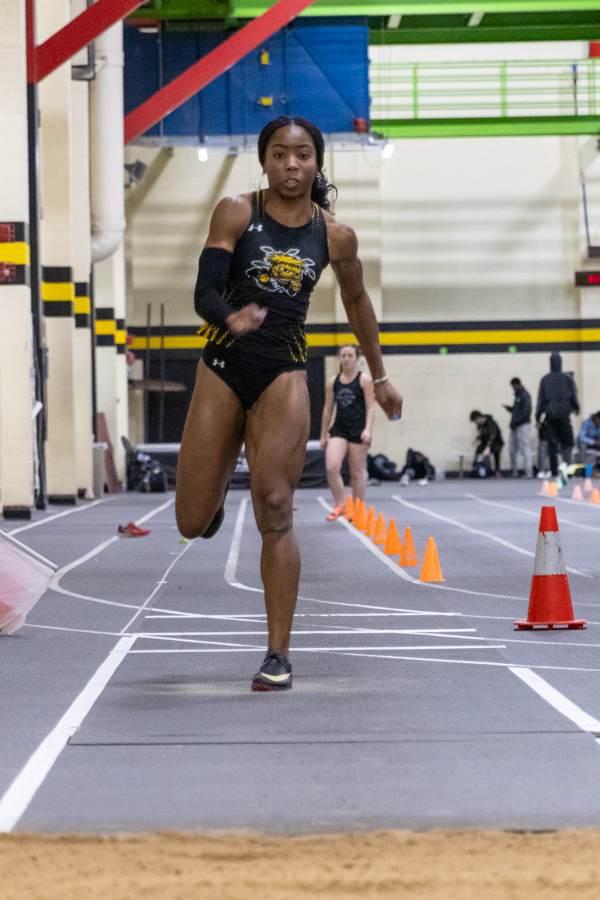 Junior Chidera Okoro jumps to the pit in her first jump of triple jump at the Wilson Invitational on Jan. 26. Okoro placed first overall with a mark of 39 feet, seven and three-quarter inches. This was a foot and a half more than the second place place winner.