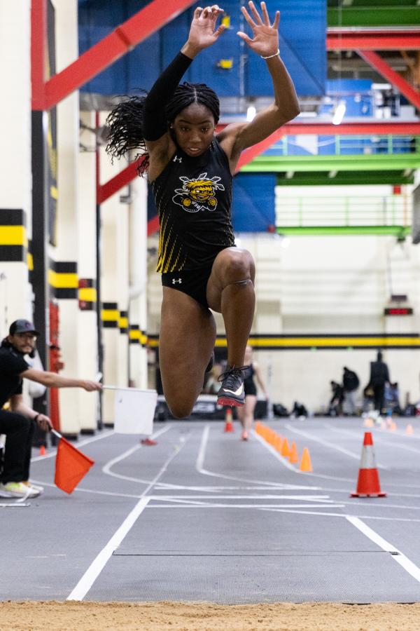 Junior Chidera Okoro jumps to the pit in her second jump of triple jump at the Wilson Invitational on Jan. 26. Okoro placed first overall.