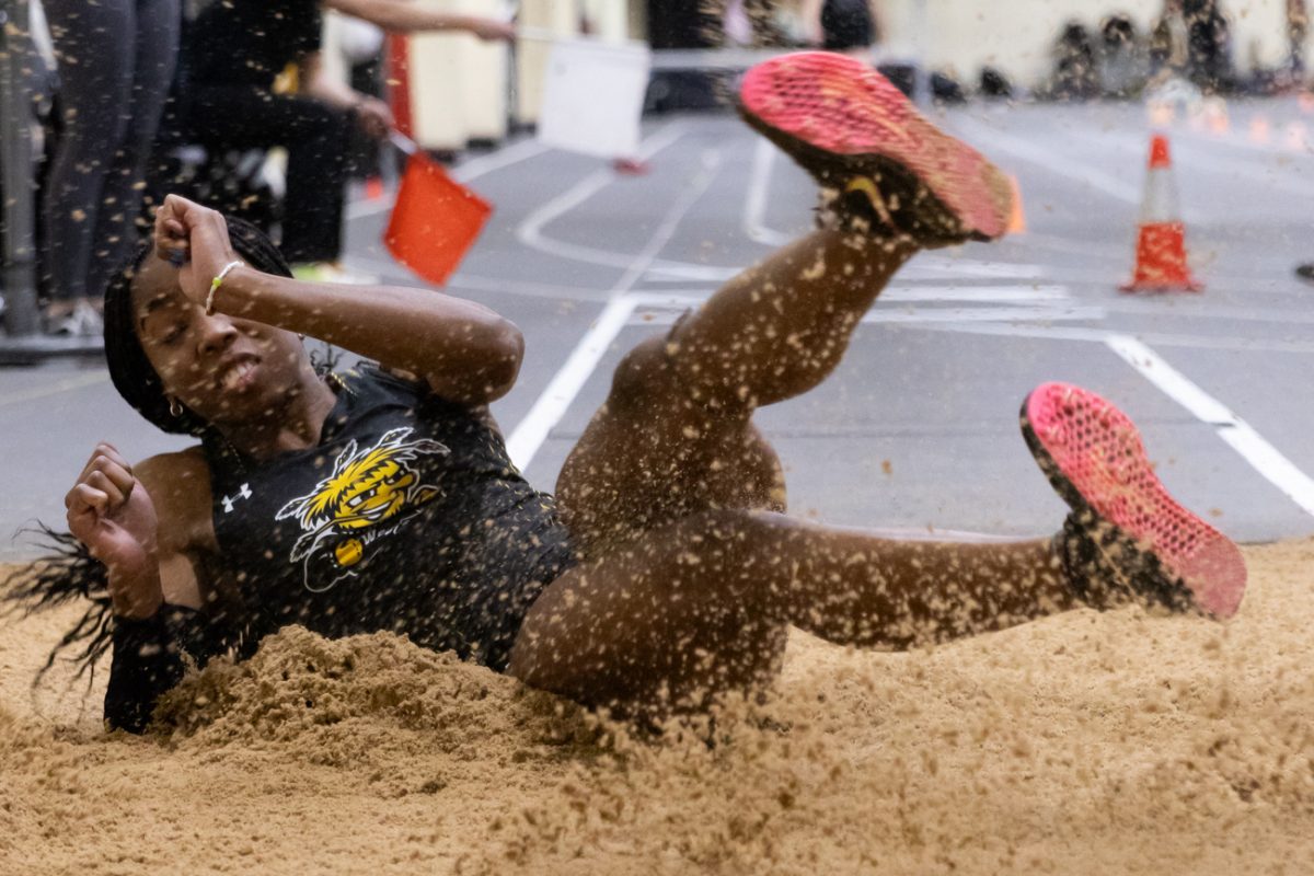 Chidera Okoro, a junior, finishes a jump in triple jump at the Wilson Invitational on Jan. 26.