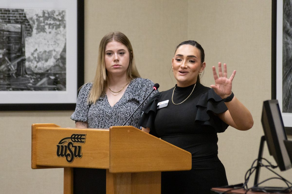 Acting President Sophie Martins and Speaker of the Senate Kylee Hower give the first read of  Retention of the Rhatigan Student Center Bond during the Student Government Association (SGA) meeting on Feb. 7.