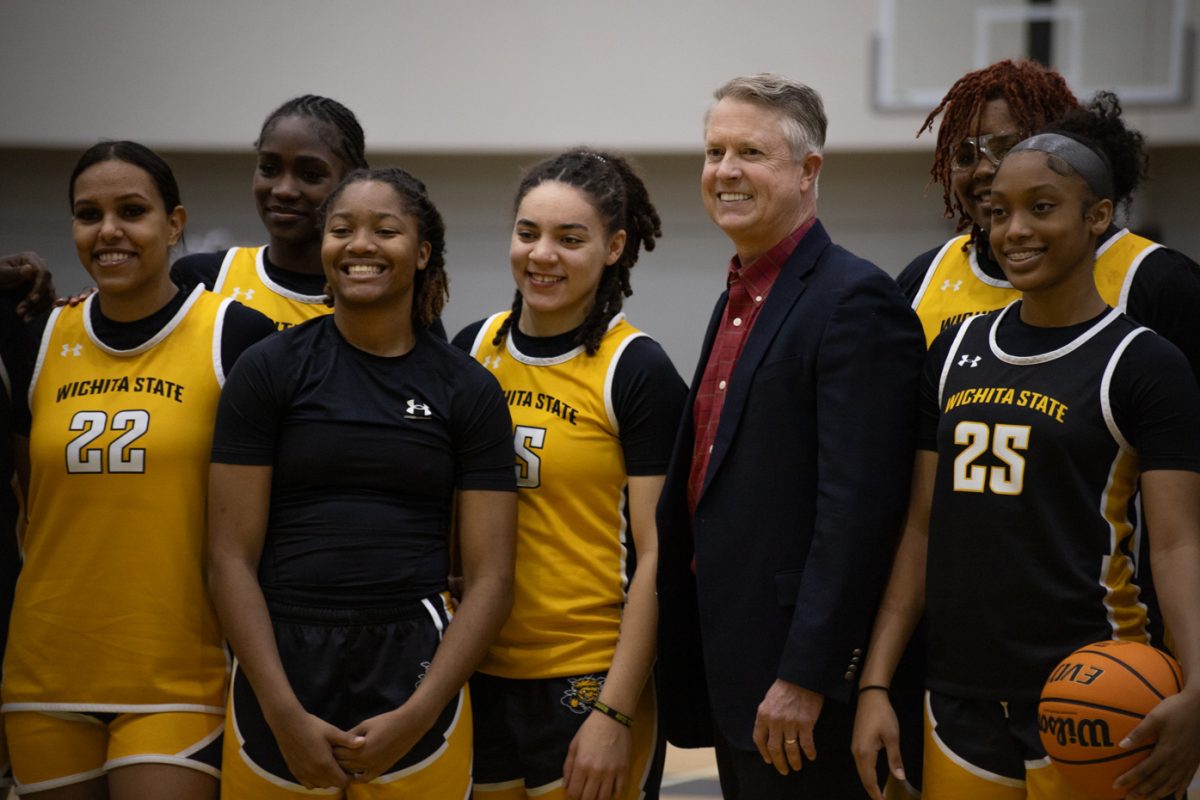 Sen. Roger Marhsall poses for a photo with the womens basketball team on Feb. 19.