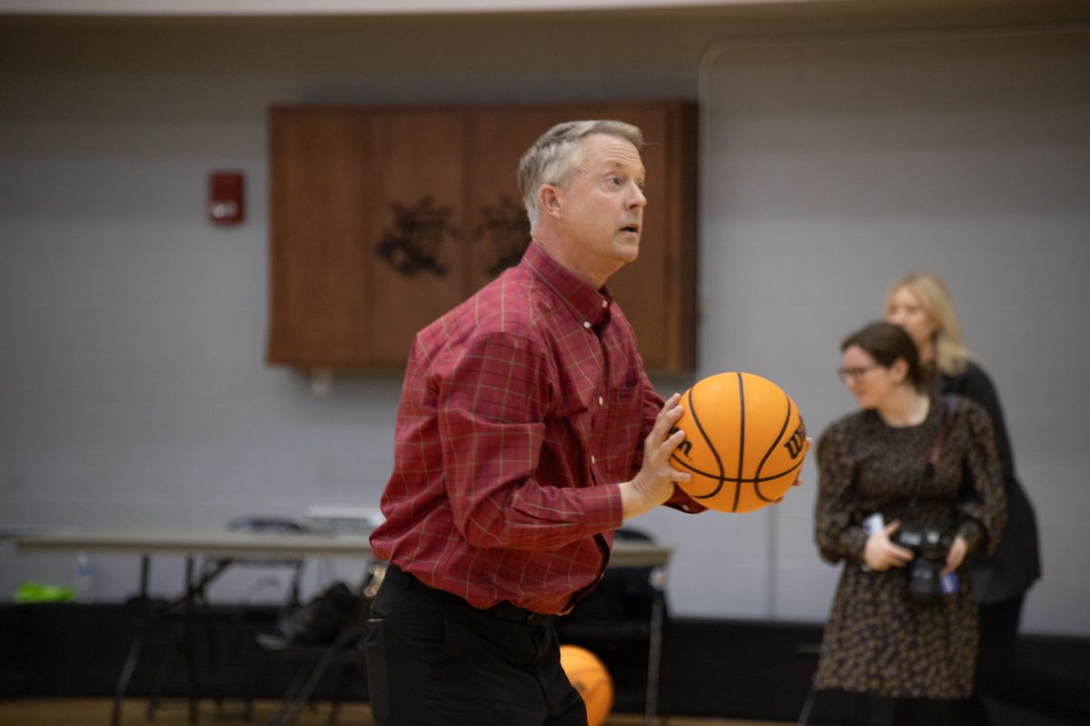 Sen. Roger Marshall prepares to shoot a basket during his visit with the womens basketball team on Feb. 19.