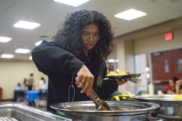 A student at the Office of Diversity and Inclusions Unity Breakfast dishes up eggs and sausage. The three-hour long event invited students, faculty and staff to mingle over complimentary breakfast.