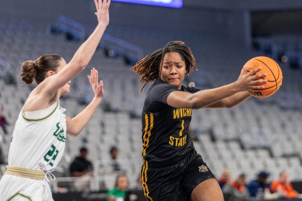 DJ McCarty runs past the South Florida defense during the AAC tournament second-round match. The senior scored four points on March 10 and a total of 171 points throughout her final collegiate season.