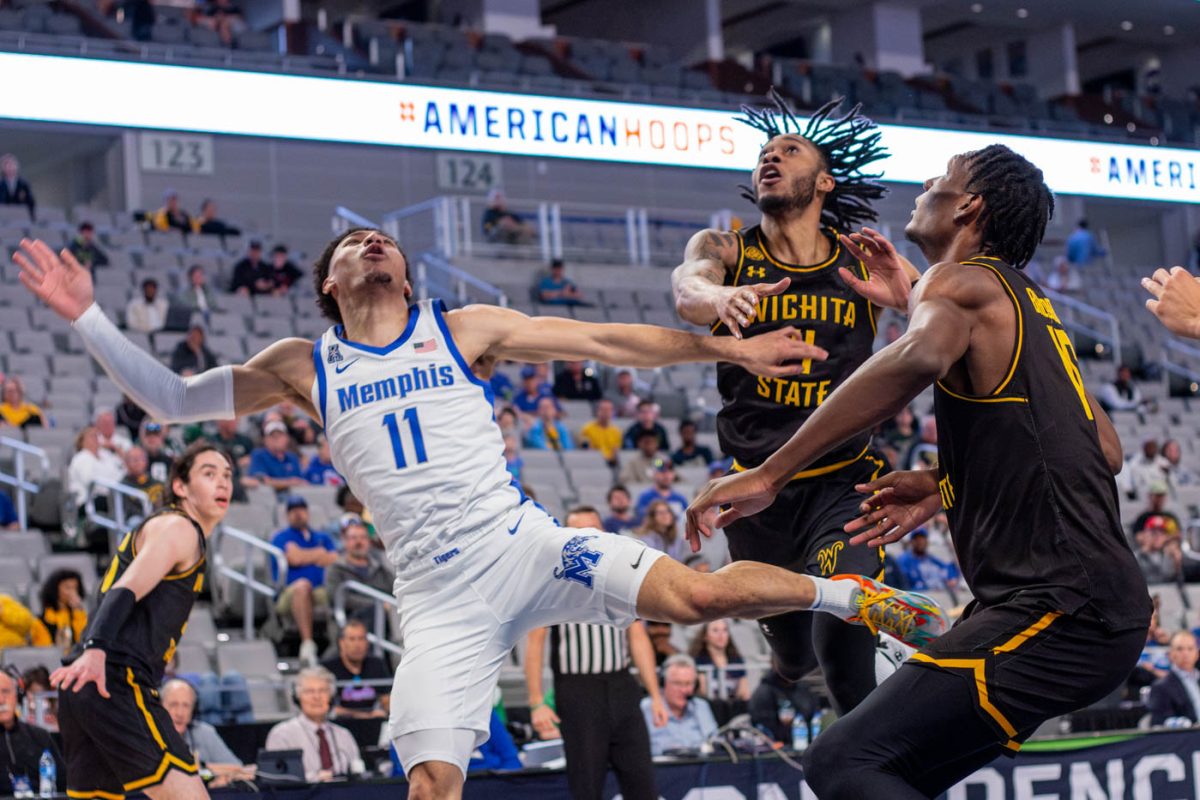 Teammates Colby Rogers and Quincy Ballard block a shot by Memphis. Wichita State defeated the Memphis 71-65 on Thursday afternoon.