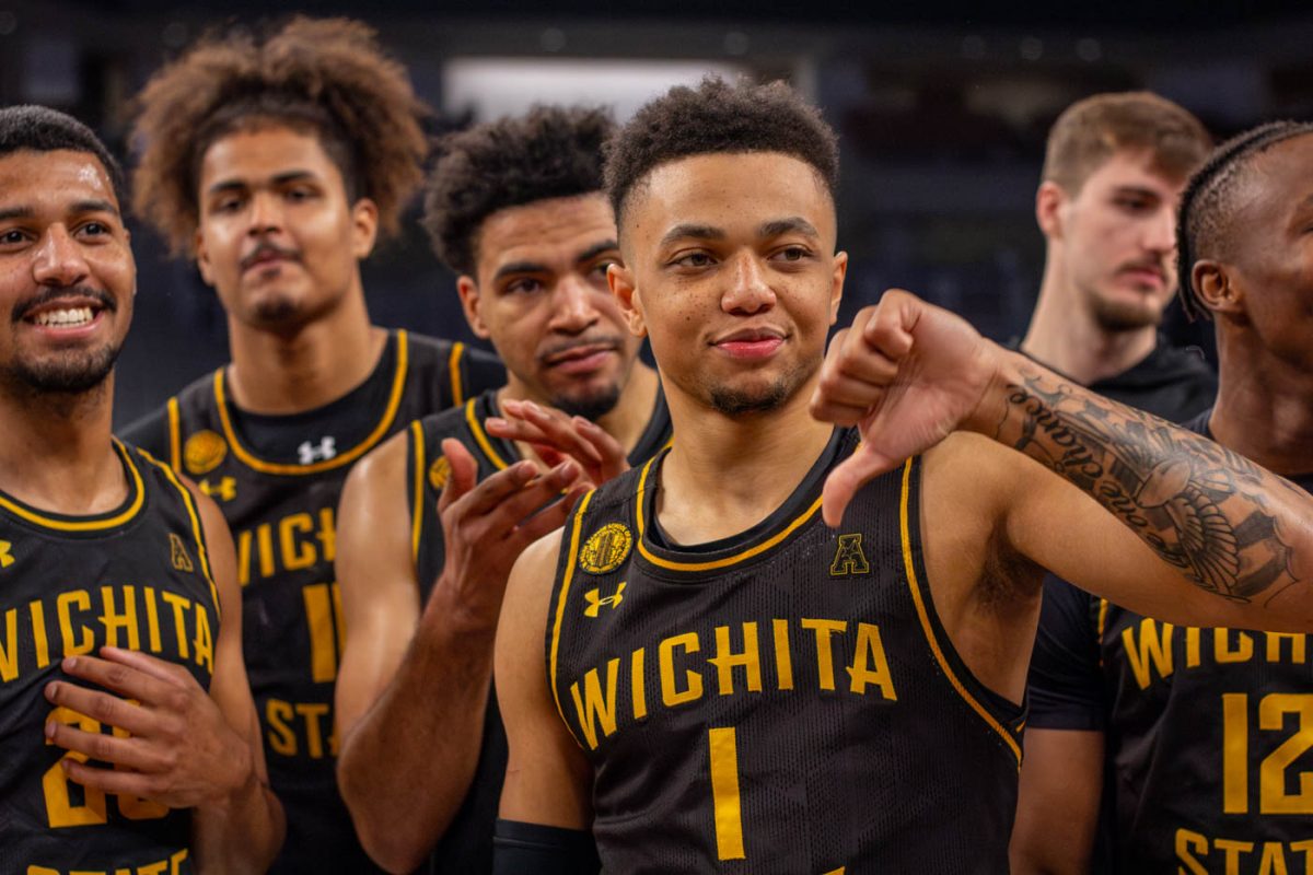 The Shockers celebrate their win versus No. 5 Memphis by holding a mocking thumbs down. The gesture is in reference to a video of Memphis played earlier in the game.