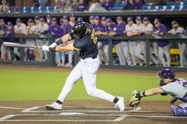 Senior Seth Stroh finishes his swing against Kansas State on March 19. Stroh had one hit in the game.