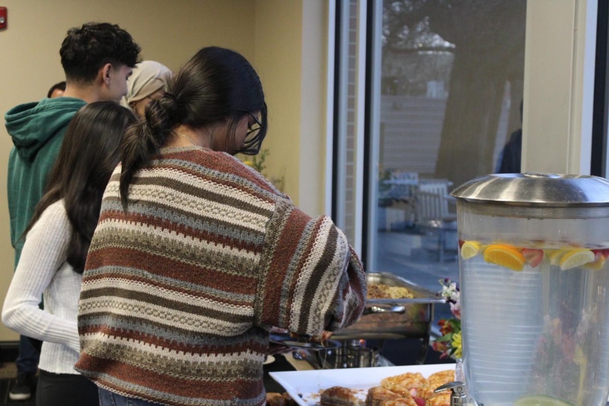 Students grab food at the Office of Diversity and Inclusions Iftar Night on March 28. Iftar is the fast-breaking meal eaten at sunset during Ramadan. Spring rolls, tandoori chicken kebabs and basmati rice were available. 