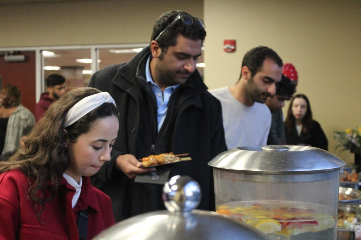 Roaa Alwazani stands in line for food at the ODI Iftar Night on March 28. The event was meant to share the meaning of Ramadan with students, Muslim and non-Muslim alike, while enjoying halal dishes.