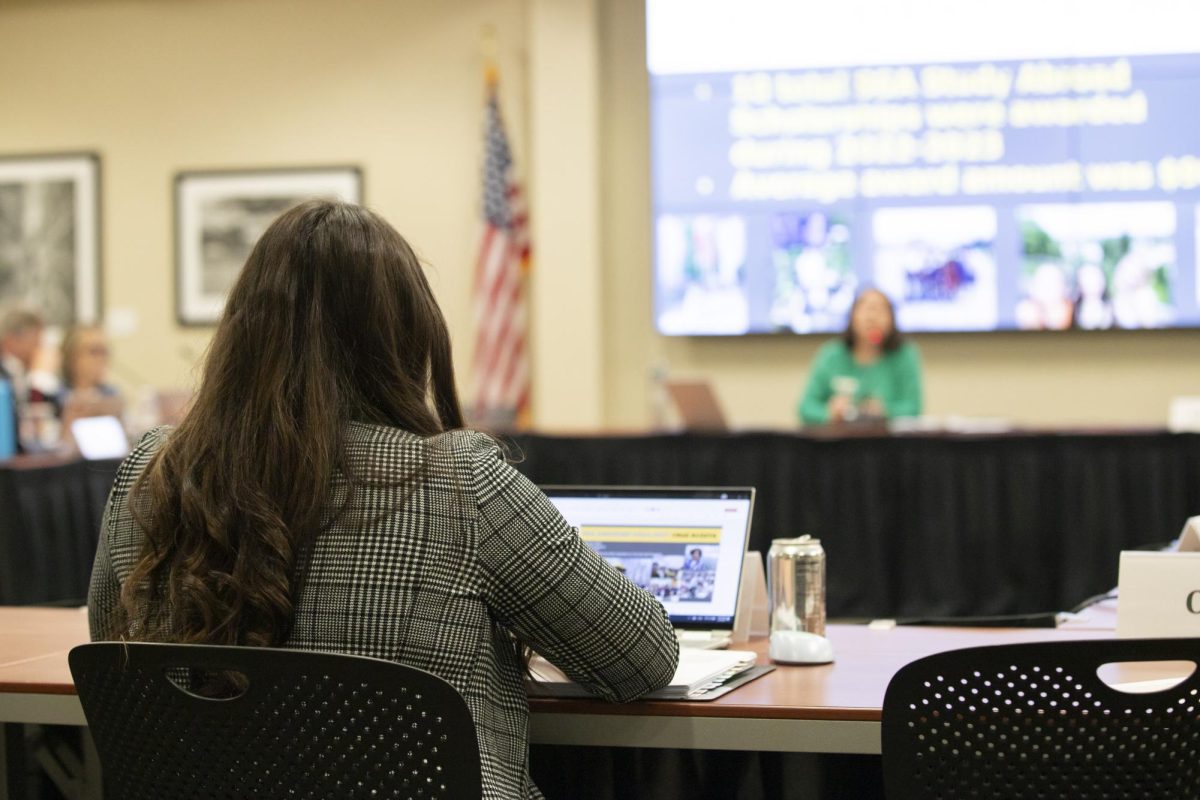 Student Body Vice President Sophie Martins takes notes while Ann Burger speaks to the Student Fees Committee on March 4. Burger serves as the associate director for Study Abroad and exchange programs at Wichita State.