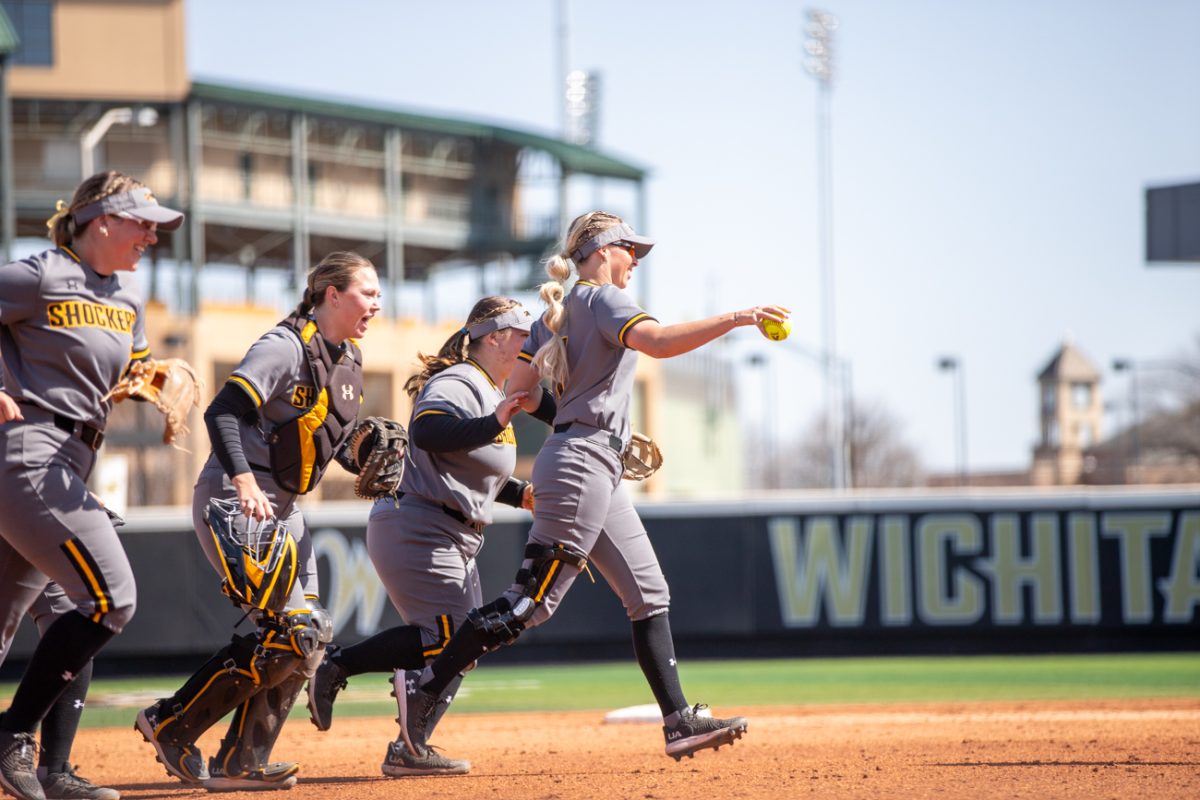 Softball players celebrate after a good play against Florida Atlantic on March 10 at Wilkins Stadium.
