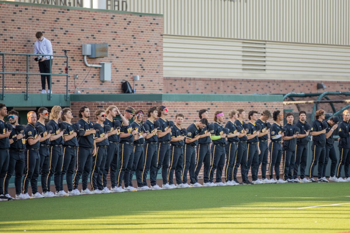 The Wichita State mens baseball team stands during the national anthem at Eck Stadium on March 12.
