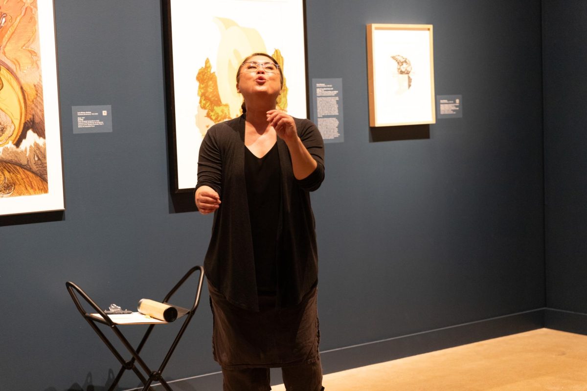 Contemporary dance director Mina Estrada leads a group in movement as she improvises a dance based on artwork for her Dancing Docents event. Dancing Docents was held in the Polk/Wilson Gallery of the Ulrich Museum and was free to the public.
