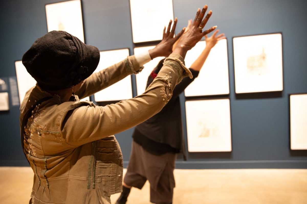 Wichitans follow contemporary dance director Mina Estrada in movement as they participate in her Dancing Docents event at the Ulrich Museum.
