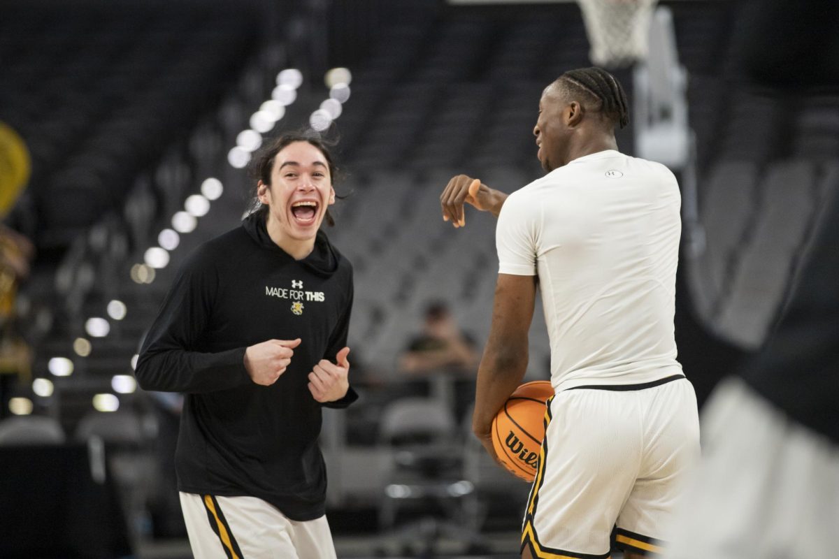 Junior guard Bijan Cortes and freshman guard Joy Ighovodja laugh together during warmup before the match against Rice University in Dickies Arena. The 88-81 win on March 13 took the Shockers to the second round of the AAC tournament.