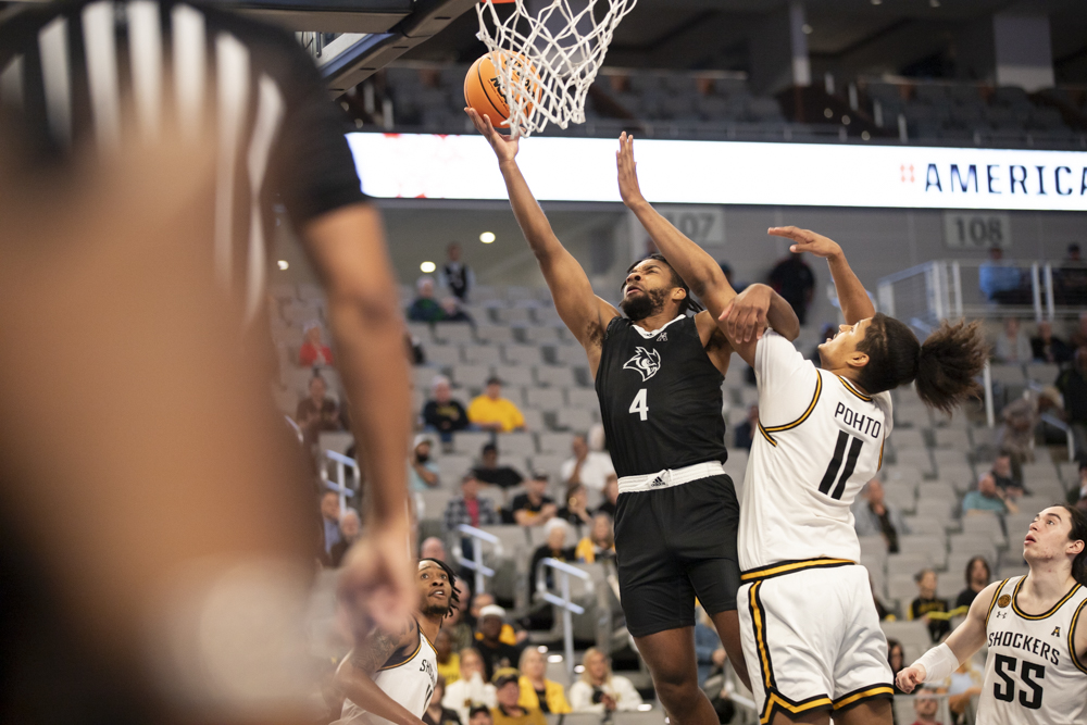 Rices Anthony Selden goes for a layup as Wichita States Kenny Pohto attempts to block the shot. The Shockers defeated the Owls, 88-81, on March 13 in Dickies Arena.