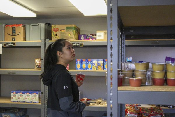 Cecillia Rivas, an exchange student from Paraguay, goes through items at Shocker Support Locker.