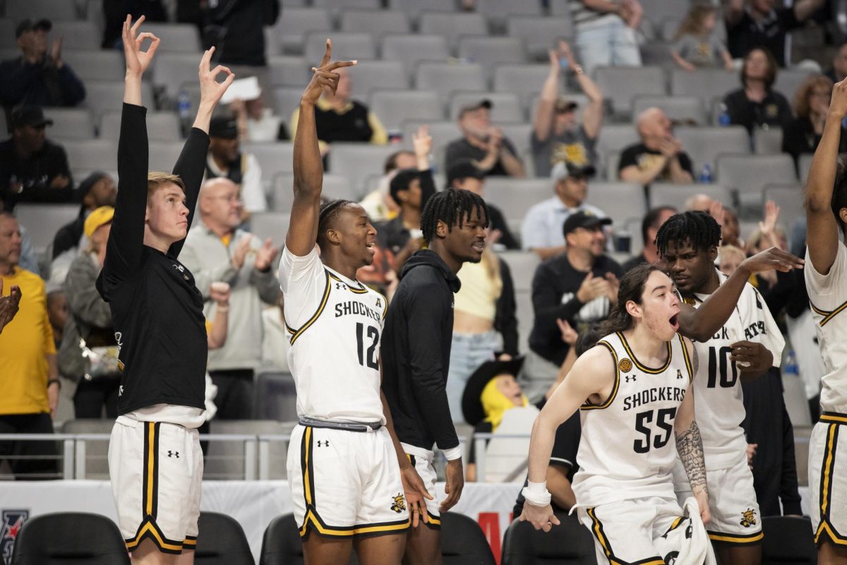 The Wichita State mens basketball team celebrates on the sidelines after a successful play by the Shockers. Wichita State won against Rice University by seven points, 88-81.