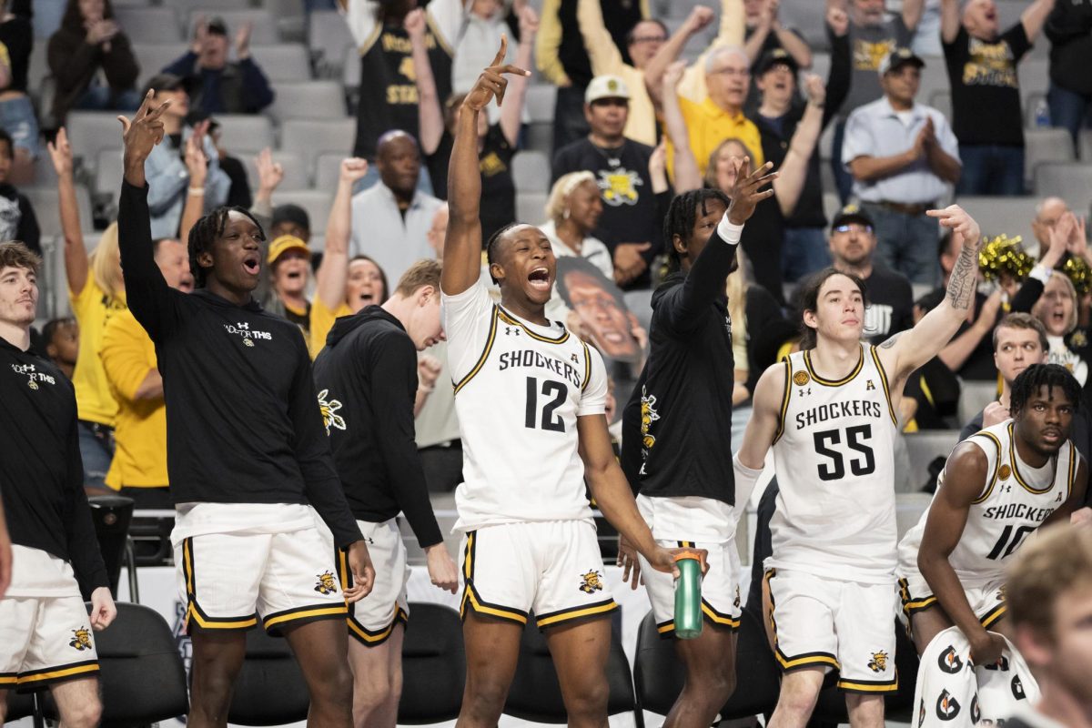 The Wichita State mens basketball team celebrates on the sidelines after a successful play by the Shockers. Wichita State won against Rice University by seven points, 88-81.