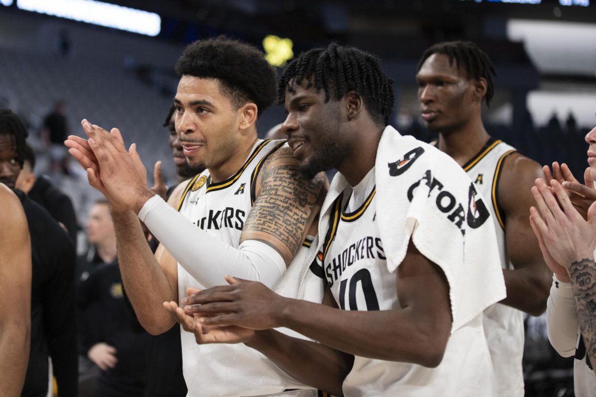 Junior forward Ronnie DeGray III and grad student forward Dalen Ridgnal clap after Wichita States win over Rice University. This win progressed the Shockers to the second round of the AAC tournament in Dickies Arena.