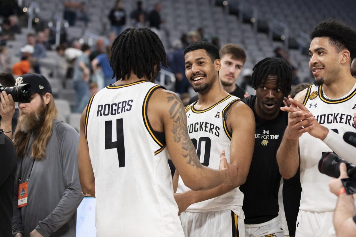 Redshirt junior guards Colby Rogers and Harlond Beverly share a moment after Wichita States win against Rice University. This win progressed the Shockers to the second round of the AAC tournament in Dickies Arena.