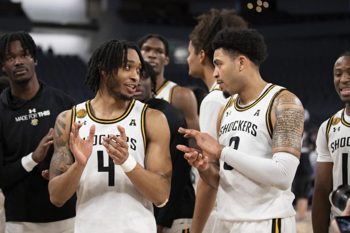 Redshirt junior guard Colby Rogers and junior forward Ronnie DeGray III clap after Wichita States win over Rice University. This win progressed the Shockers to the second round of the AAC tournament in Dickies Arena.