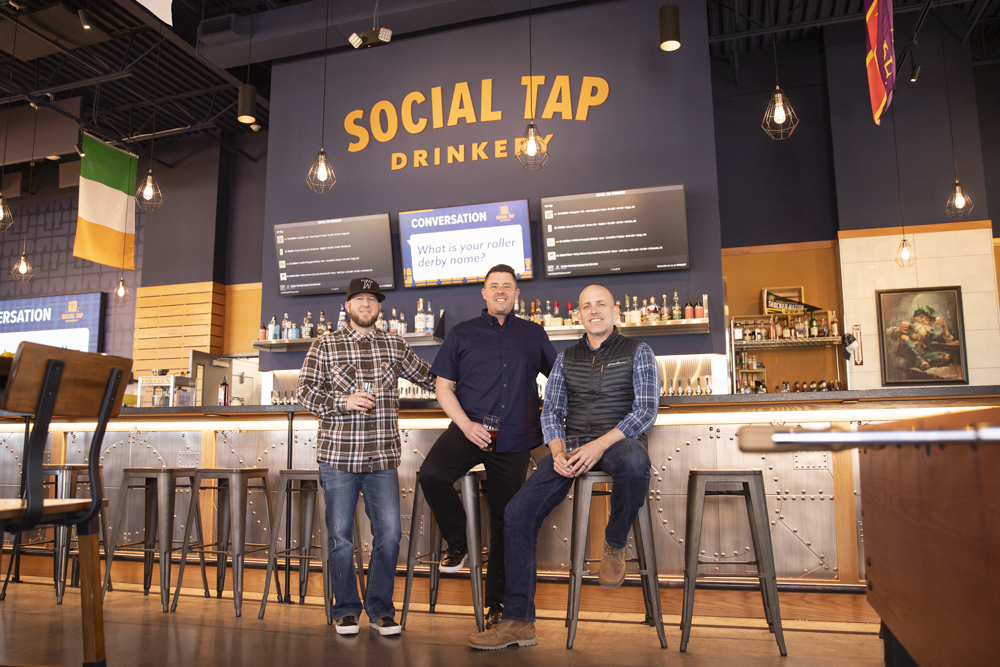 David Hopkins, Justin Neel and Luke Luttrell pose for a photo at their restaurant Social Tap on March 27. The alumni all attended Wichita State.