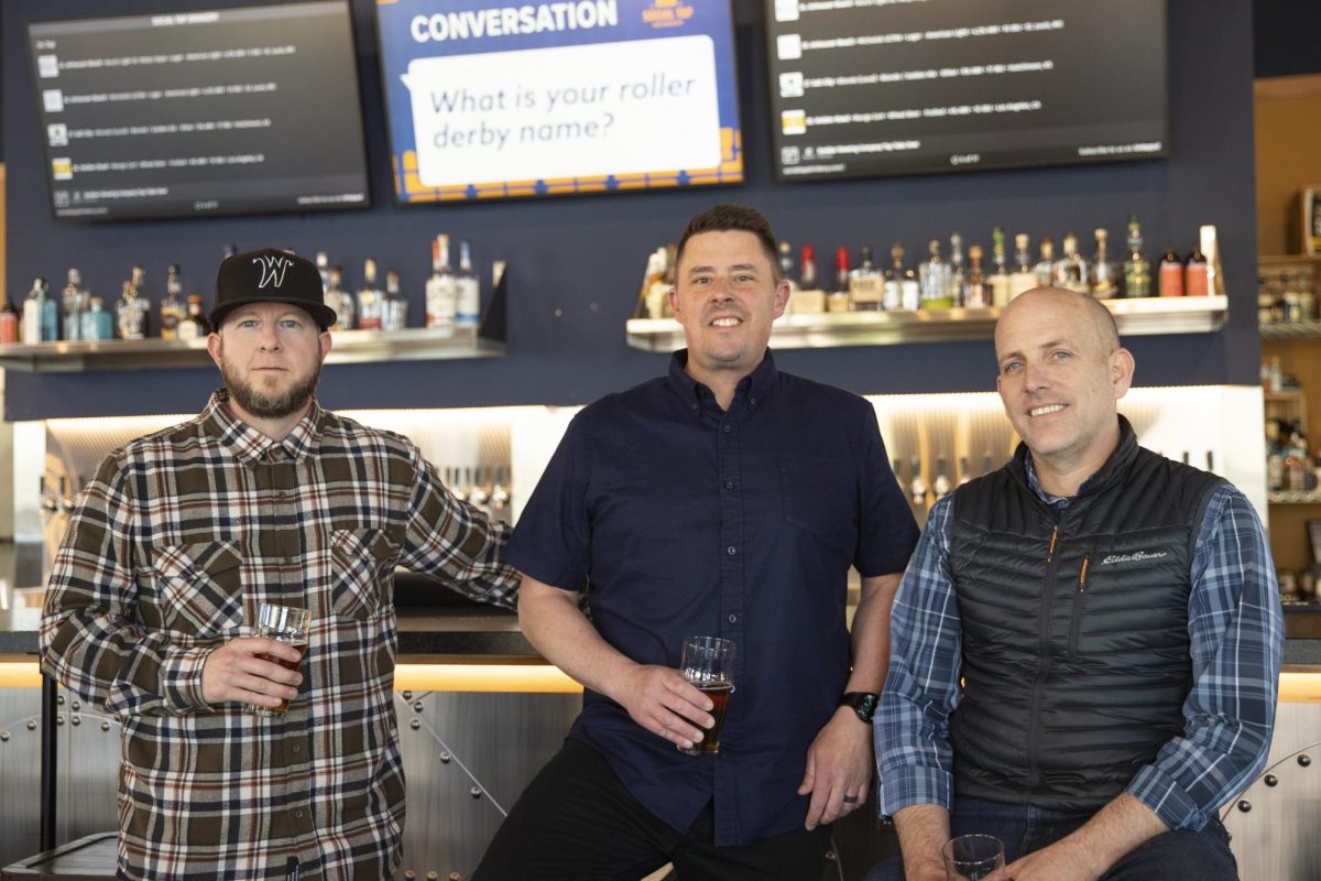 David Hopkins, Justin Neel and Luke Luttrell pose for a photo at their restaurant Social Tap on March 27. The alumni all attended Wichita State.