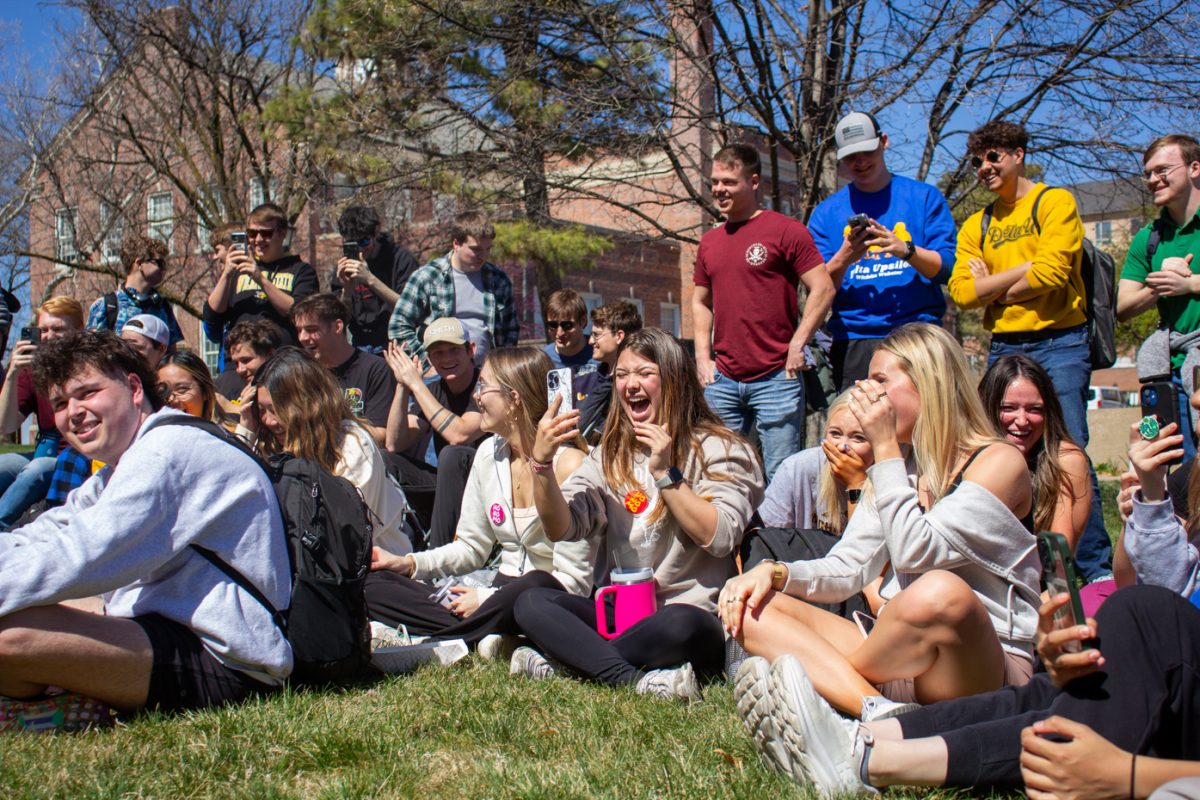 Students laugh and take videos as Sister Cindy shares her messages of Christianity and modesty to Wichita State students. More than 50 students stopped to listen to Sister Cindys teachings during her sermons on March 19 and 20.