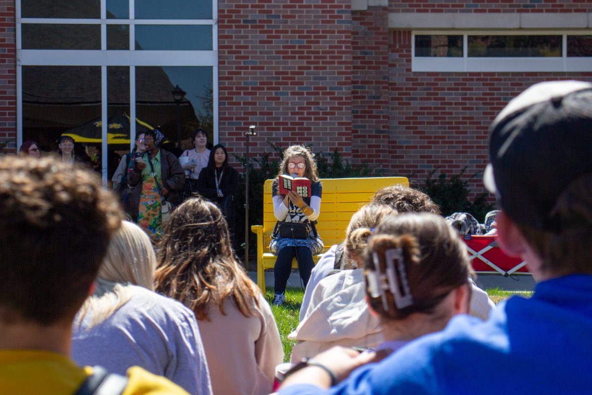 Sister Cindy reads verses from her Bible to students while visiting campus on Tuesday. Students were asked trivia questions and, if they responded correctly, were given a Ho No Mo button.