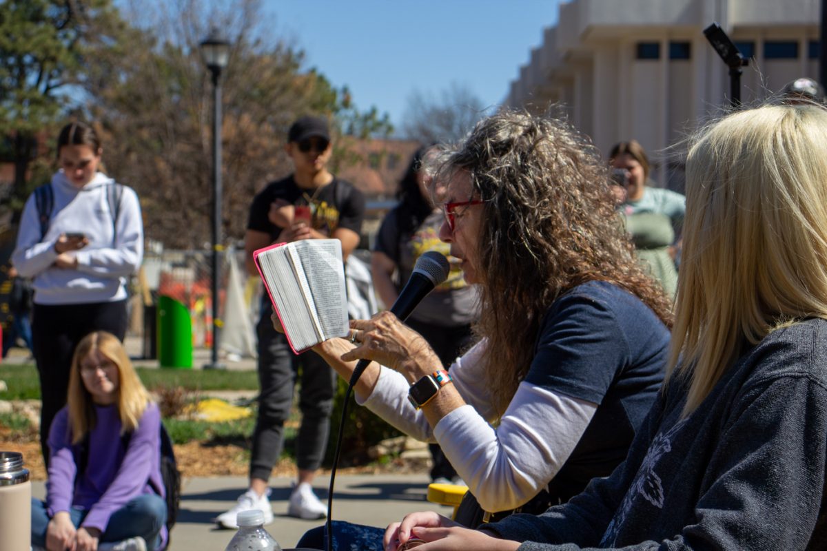 Sister Cindy reads Bible verses to a student during her speech on Tuesday afternoon. Students were invited to share a bench with Sister Cindy while she quizzed or questioned them on the Bible or issues of morality.