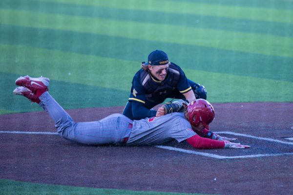 Sophomore Alex Birge tags an Oklahoma player at home plate to get an out on April 2 against Oklahoma. Birge put out seven outs.