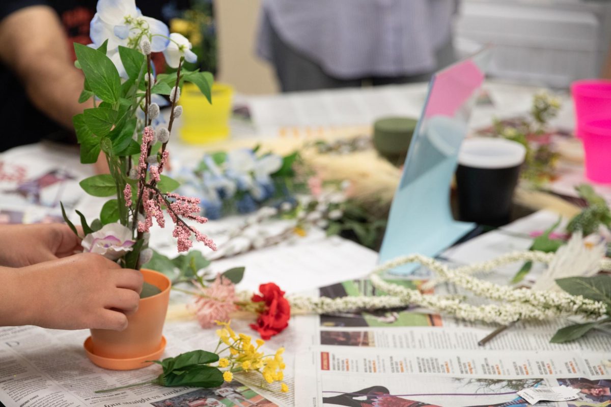 Students engage in a flower arrangement station, one of the activities available at the Japan Festival hosted by Asian Student Conference Dance and the Japanese Cultural Association. This was one of the multiple interactive activities available for attendees. 