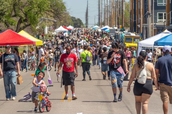 The crowded 17th Street during Open Streets ICT. The street was blocked off from traffic to allow for vendors, local organizations and artists to table. Event goers were able to bike, walk and mingle while browsing tables. 