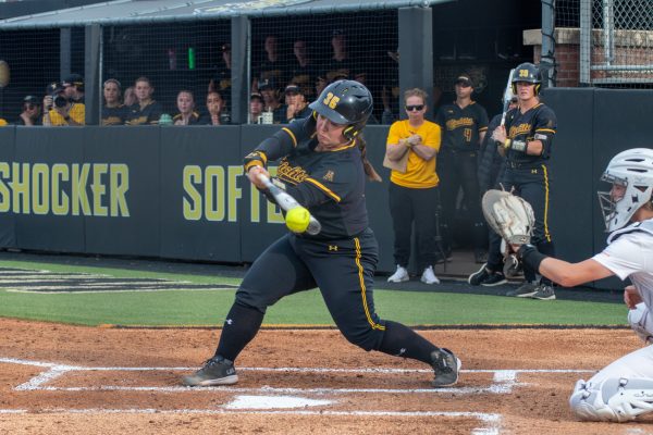 Graduate student CC Wong hits the ball during the game against Oklahoma State. The Shockers lost their home game at Wilkins Stadium, 6-5.