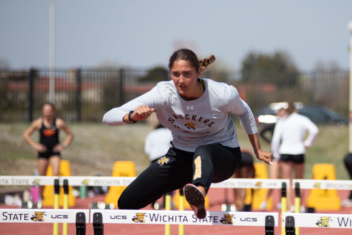 Tess+Roman+warms+up+for+hurdles+before+the+race+starts+at+the+Shocker+Spring+Invitational.+Roman+ran+the+100-meter+hurdles+in+15.53+seconds+for+Wichita+State.