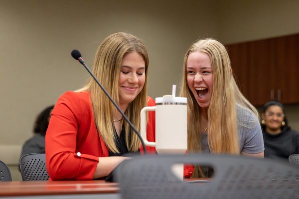 Student Body President-elect Kylee Hower grins with Tessa Fry, the clerk of the Senate, as the unverified SGA 2024 General Election results are announced during Wednesday nights Student Senate meeting. Hower and her vice president, Matthew Phan, received 59.95% of the student bodys votes.