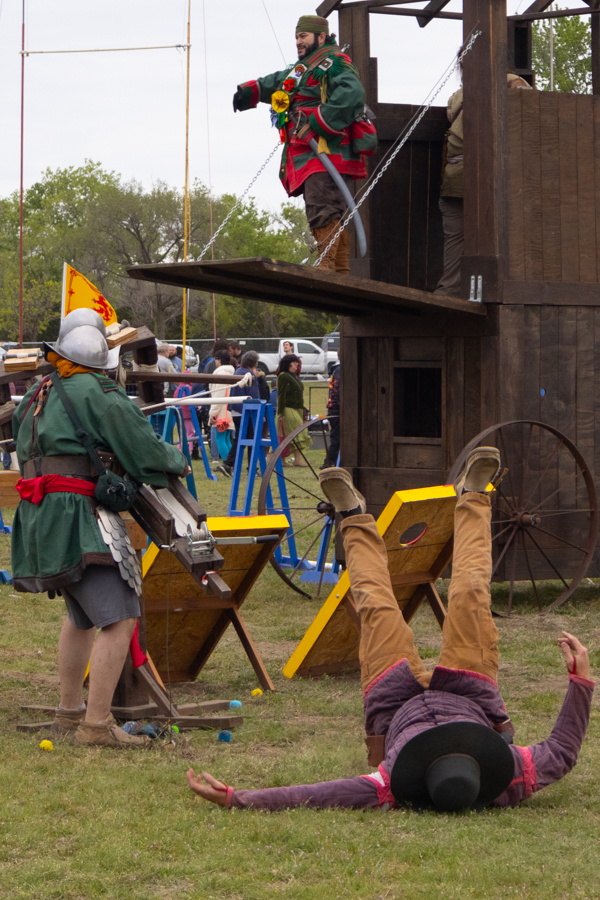 Two men reenact a catapult at the Great Plains Renaissance Festival on April 20. The catapult was used for a game of cornhole. 