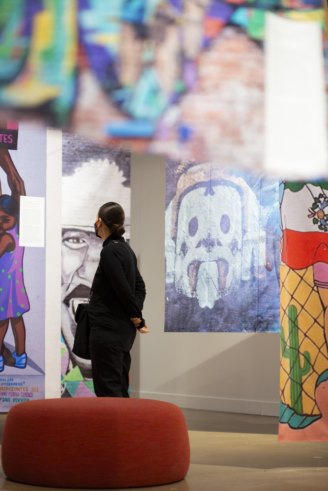 A museum-goer examines artwork from Horizontes, a Wichita community art project. The Horizontes work was on display in the Ulrich Museum of Art on April 11.