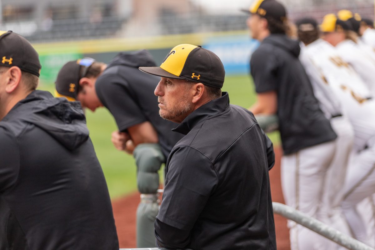 Head+baseball+coach+Brian+Green+focuses+on+the+game+from+the+dugout+against+Oklahoma+State+University.+Wichita+State+lost+9-5+at+Riverfront+Stadium+on+April+10.