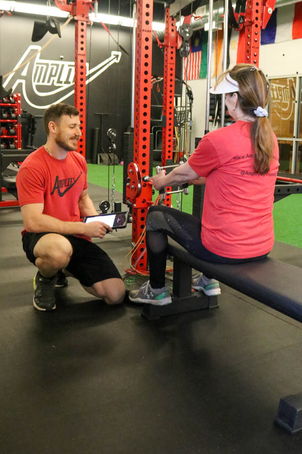 Andy Sykes talks to a customer after her set on April 29th. Sykes is focusing on his fitness company, Amplify My Training.