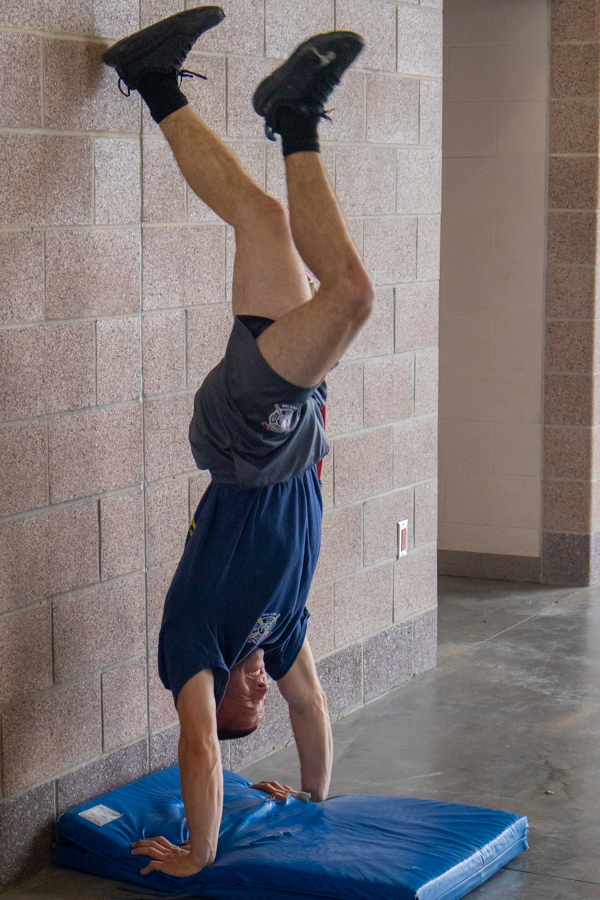 Firefighter Jared Kornfeld does a handstand pushup during a Sedgwick County Fire District 1 Station 32 workout on April 19.